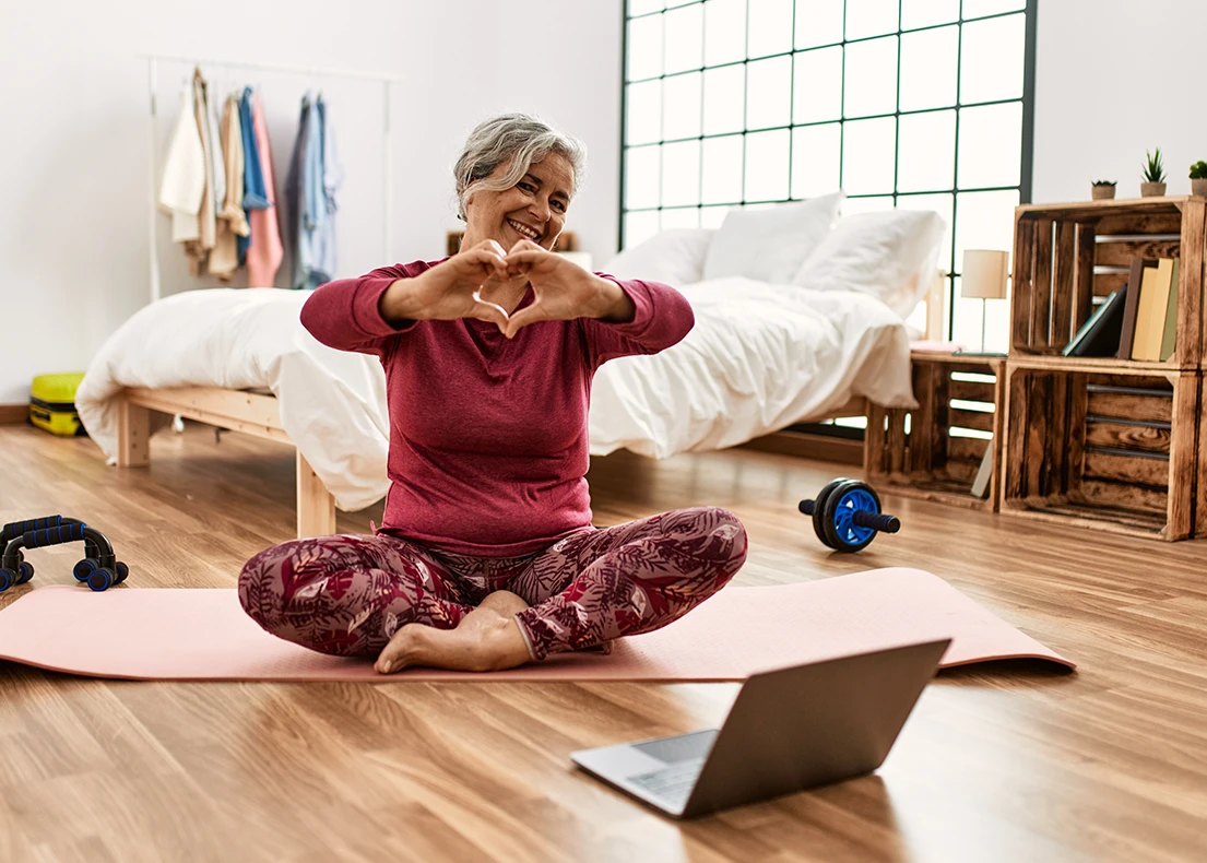 Woman sitting on a yoga mat in a room